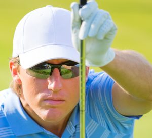 Man wearing specialty eyewear while golfing